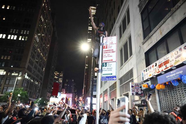 New York Knicks fans celebrate outside Madison Square Garden after their team’s Game 4 victory over the San Antonio Spurs in the NBA Finals in New York on June 10, 2026. (Photo by CHARLY TRIBALLEAU / AFP)