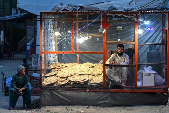 A vendor selling bread waits for customers along a street in Argo district of Afghanistan's Badakhshan province (Photo by OMER ABRAR / AFP)
