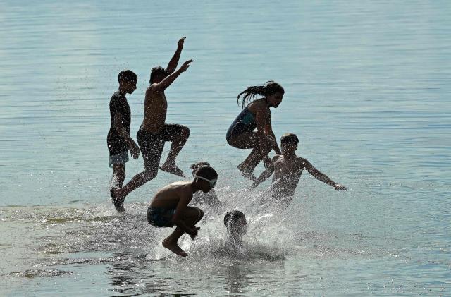Children plunge into the waters of Lake Ohrid to cool off on a warm day in the village of Pestani, near Ohrid, on June 10, 2026. (Photo by Robert ATANASOVSKI / AFP)