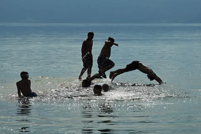 Children plunge into the waters of Lake Ohrid to cool off on a warm day in the village of Pestani, near Ohrid, on June 10, 2026. (Photo by Robert ATANASOVSKI / AFP)
