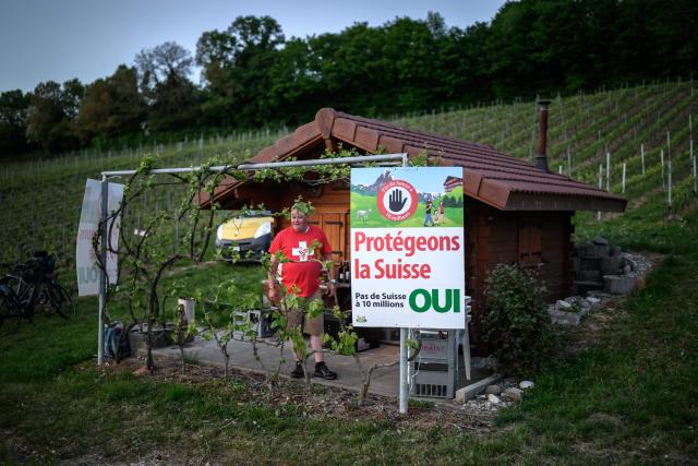 Olivier Agassis, a winegrower and local representative of the Swiss People's Party (SVP/UDC), poses in front of his vineyard hut in Bavois, western Switzerland, on May 1, 2026. The Swiss will vote on June 14, 2026 on a divisive anti-immigration proposal to cap the country's population, with the result expected to be tight and warnings of "chaos" if it passes. Put forward by the far-right Swiss People's Party, the proposal would require drastic cuts to immigration that critics warn risk crippling swathes of the economy and Switzerland's relations with the European Union, its main trading partner. (Photo by Fabrice COFFRINI / AFP)
