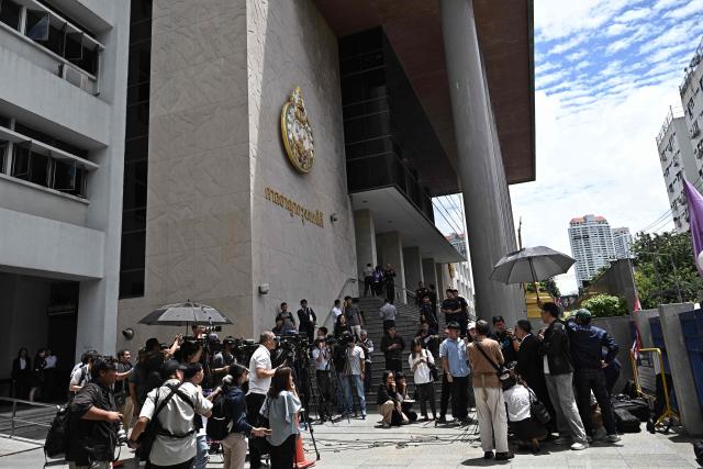 Lawyer Choochat Kanpai (R) representing bombing suspects Bilal Mohammed and Yusufu Mieraili, speaks to the media at the Bangkok South Criminal Court in Bangkok on June 11, 2026, after the verdict for the Erawan Shrine bombing on August 17, 2015. Two Uyghur men were sentenced to death on June 11 for carrying out a 2015 attack on a Bangkok shrine that killed 20 people, a long-awaited verdict in Thailand's deadliest bombing case. (Photo by Lillian SUWANRUMPHA / AFP)