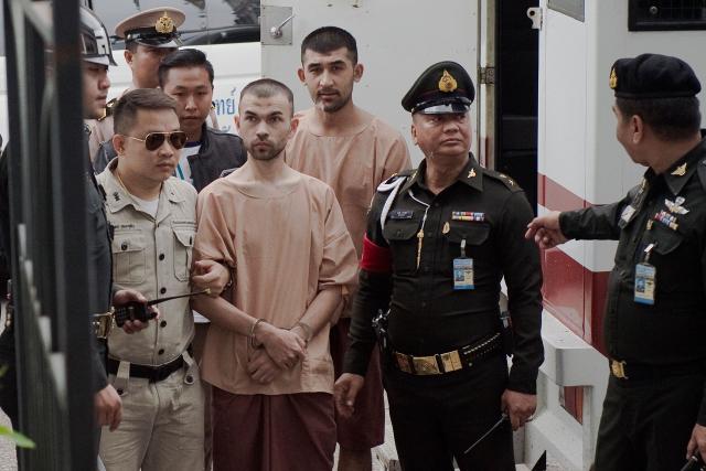 (FILES) Suspects in the 2015 Erawan shrine bombing Bilal Mohammed (C) and Yusufu Mieraili (back R) arrive at a military court in Bangkok on February 16, 2016. Two Uyghur men were sentenced to death on June 11, 2026 for carrying out a 2015 attack on a Bangkok shrine that killed 20 people, a long-awaited verdict in Thailand's deadliest bombing case. (Photo by NICOLAS ASFOURI / AFP)
