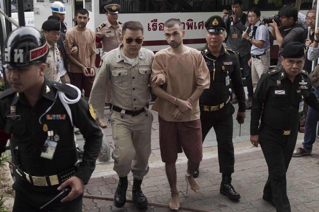 (FILES) Suspects in the 2015 Erawan shrine bombing Bilal Mohammed (C) and Yusufu Mieraili (back L) arrive at a military court in Bangkok on February 16, 2016. Two Uyghur men were sentenced to death on June 11, 2026 for carrying out a 2015 attack on a Bangkok shrine that killed 20 people, a long-awaited verdict in Thailand's deadliest bombing case. (Photo by NICOLAS ASFOURI / AFP)