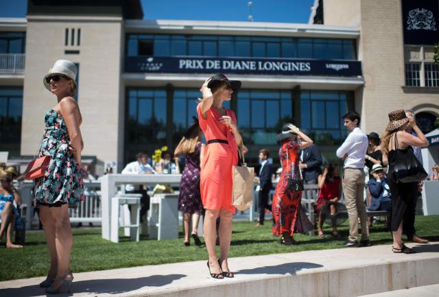 (FILES) A woman looks on prior to the start of the Prix de Diane, a 2,100-meters flat horse race, at the Chantilly hippodrome, north of Paris on June 18, 2017. Two weeks after Irish thoroughbred Constitution River's victory in the Prix du Jockey-Club, eleven three-year-old thoroughbred fillies compete on June 14, 2026 in Chantilly for the European title over 2,100 metres in the Prix de Diane, the most glamorous racing event of the year. (Photo by Martin BUREAU / AFP)