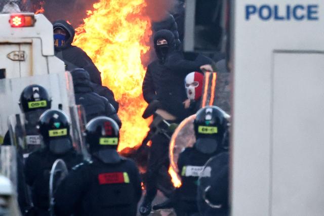 Protesters clash with police blocking their way to a hotel previously believed to house migrants, in Glengormley, north of Belfast, Northern Ireland, on June 10, 2026. Police used water cannon late on June 10 to disperse small crowds who had gathered for a second night in Northern Ireland as UK authorities blamed far-right activists for stoking anger on social media following a brutal stabbing. (Photo by HENRY NICHOLLS / AFP)