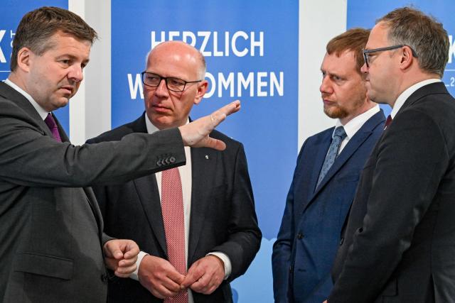 Saxony-Anhalt's State Premier Sven Schulze (L), Berlin mayor Kai Wegner (2n,L),Saxony's State Premier Michael Kretschmer (2nd,R) and Thuringia's State Premier Mario Voigt arrive for a conference of the state leaders of Germany's eastern federal states in Schoenefeld, southeast of Berlin, on June 11, 2026. (Photo by RALF HIRSCHBERGER / AFP)