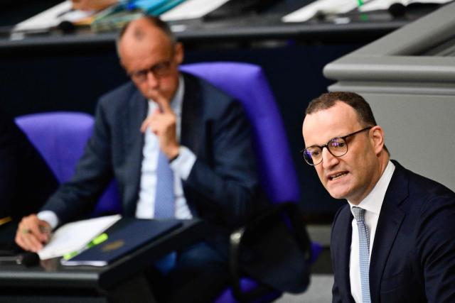 Parliamentary group leader of Germany's Christian Democratic Union (CDU) Jens Spahn speaks standing next to German Chancellor Friedrich Merz during a sitting of the German Bundestag (lower house of parliament) on June 11, 2026, ahead of an EU summit. (Photo by John MACDOUGALL / AFP)