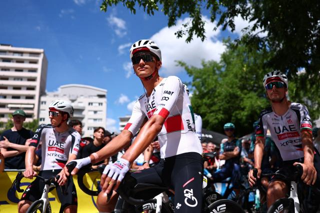 UAE Team Emirates XRG's Mexican rider Isaac Del Toro Romero (C) and UAE Team Emirates XRG's Portuguese rider Joao Almeida react ahead of the start of the 5th stage of the Tour Auvergne-Rhone-Alpes cycling race (formerly known as the Criterium du Dauphine), 195,8km between Saint-Chamond and Villars-les-Dombes, central France, on June 11, 2026. (Photo by Anne-Christine POUJOULAT / AFP)
