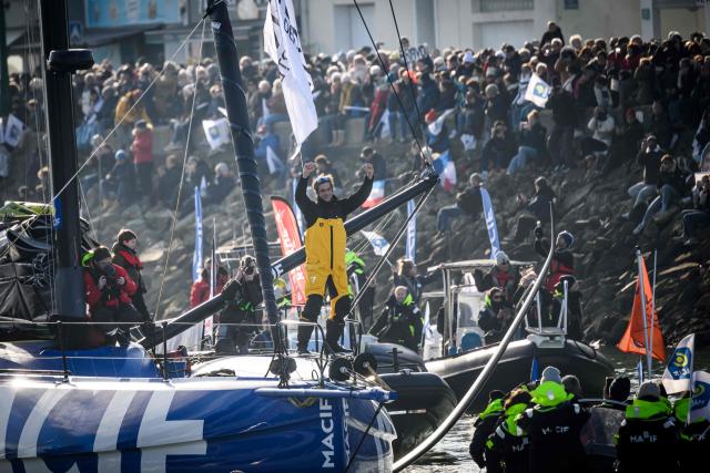 (FILES) French skipper Charlie Dalin celebrates upon his arrival at the harbour after winning the 10th edition of the Vendee Globe around the world monohull solo sailing race, in Les Sables-d'Olonne, western France, early on January 14, 2025. French offshore sailor and Vendee Globe 2024/2025 winner Charlie Dalin has died in Quimper, western France, aged 42, from cancer, his family announced on June 11, 2026. (Photo by Loic VENANCE / AFP)