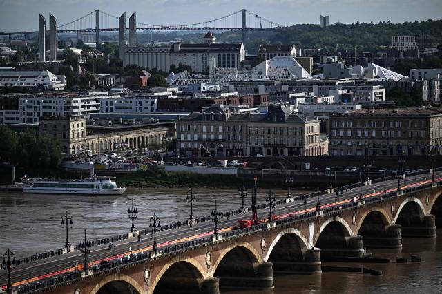 This photograph taken from the top of the restored Saint-Michel bell tower shows the Pont de Pierre (bottom) over the Garonne river in Bordeaux, southwestern France on June 11, 2026. The 114-meter high Saint-Michel, built at the end of the 15th century, is set to reopen to the public on June 13 following five years of restoration. (Photo by Christophe ARCHAMBAULT / AFP)
