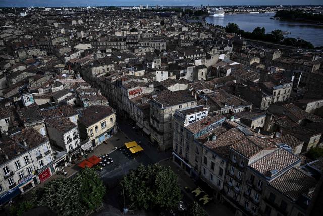 This photograph taken from the top of the restored Saint-Michel bell tower shows a cruise ship docked at the Bordeaux port along the Garonne river in Bordeaux, southwestern France on June 11, 2026. The 114-meter high Saint-Michel, built at the end of the 15th century, is set to reopen to the public on June 13 following five years of restoration. (Photo by Christophe ARCHAMBAULT / AFP)