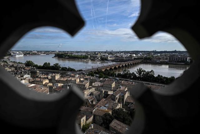 This photograph taken from the top of the restored Saint-Michel bell tower shows the Pont de Pierre over the Garonne river in Bordeaux, southwestern France on June 11, 2026. The 114-meter high Saint-Michel, built at the end of the 15th century, is set to reopen to the public on June 13 following five years of restoration. (Photo by Christophe ARCHAMBAULT / AFP)