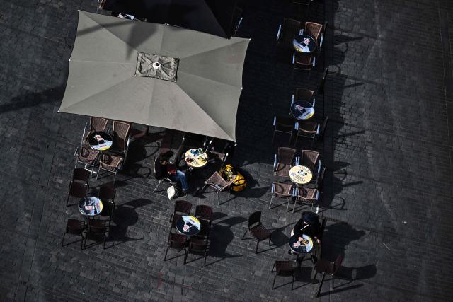 This photograph taken from the top of the restored Saint-Michel bell tower shows people sitting at the terrasse of a cafe in Bordeaux, southwestern France on June 11, 2026. The 114-meter high Saint-Michel, built at the end of the 15th century, is set to reopen to the public on June 13 following five years of restoration. (Photo by Christophe ARCHAMBAULT / AFP)