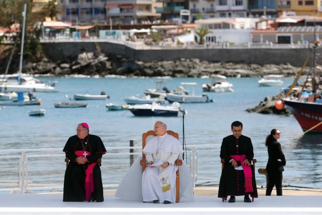 Pope Leo XIV (C) attends a meeting with organizations working with migrants in the port of Arguineguin on the Canary Island of Gran Canaria, a place accustomed to the arrival of migrants, on June 11, 2026. Pope Leo XIV is visiting Spain June 6-12 with stops in Madrid, Barcelona, and the Canary Islands, where he will meet with migrants and organisations dedicated to helping them. (Photo by Pierre-Philippe MARCOU / AFP)