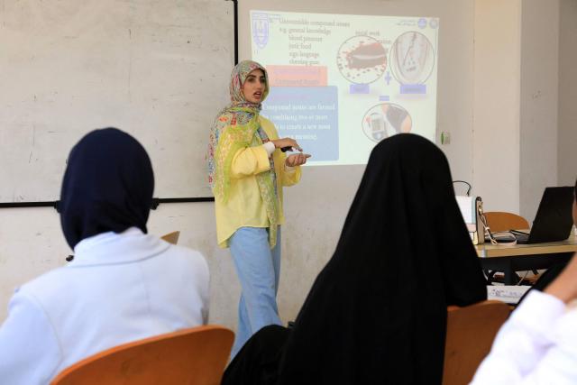 Students attend a lecture at the University of Benghazi, in Benghazi on May 20, 2026. A decade after fierce battles reduced much of the University of Benghazi to rubble, students at Libya's oldest and largest university are once again looking to the future with optimism. The university, founded in 1955, had become after the 2011 uprisings that toppled and killed longtime ruler Muammar Gaddafi the stage of intense fightings between jihadist groups and forces led by military strongman Khalifa Haftar. (Photo by Abdullah DOMA / AFP) / To go with 'Libya-Youth-Development-Education', REPORTAGE by Françoise KADRI