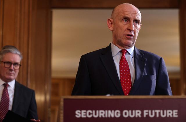 (FILES) Britain's Prime Minister Keir Starmer (L) listens as Britain's Defence Secretary John Healey speaks to apprentices and representatives from SMEs in the defence industry, during a careers fair inside 10 Downing Street in central London on March 3, 2025. British Defence Secretary John Healey resigned on June 11, 2026, in a surprise move which he said was due to Prime Minister Keir Starmer and his finance ministry failing to commit sufficient resources to long-term defence plans. (Photo by Adrian Dennis / POOL / AFP)