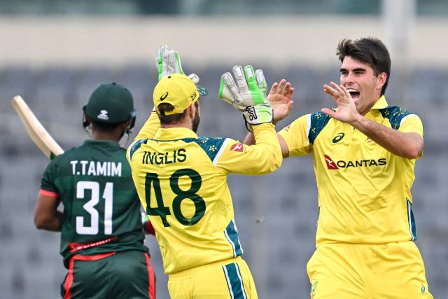Australia's Xavier Bartlett (R) celebrates with his captain Josh Inglis (C) after taking the wicket of Bangladesh's Tanzid Hasan during the second one-day international (ODI) cricket match between Bangladesh and Australia at the Sher-e-Bangla National Stadium in Dhaka on June 11, 2026. (Photo by Munir UZ ZAMAN / AFP)