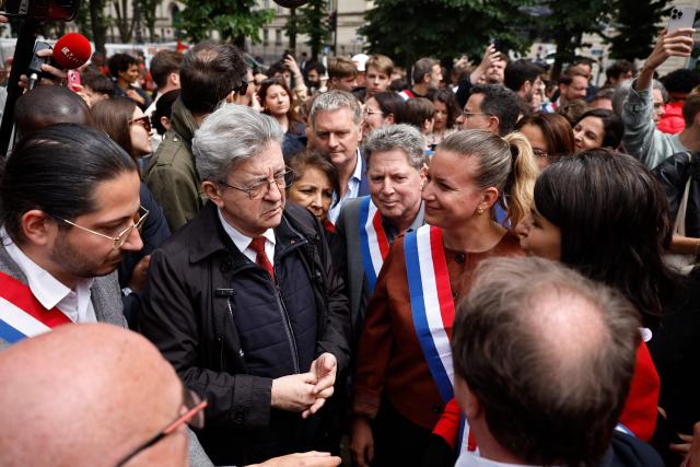 (From L) La France Insoumise - Nouveau Front Populaire's MP Aurelien Le Coq, Founder of French left-wing party La France Insoumise (LFI) and presidential candidate Jean-Luc Melenchon and President of La France Insoumise - Nouveau Front Populaire parliamentary group Mathilde Panot gather with ArcelorMittal workers at the esplanade des Invalides outside the National Assembly, France's lower house of parliament, during a demonstration in support of the nationalisation of steelmaking giant ArcelorMittal, called by the General Confederation of Labour (CGT), as the bill comes before the National Assembly in Paris on June 11, 2026. (Photo by SIMON WOHLFAHRT / AFP)