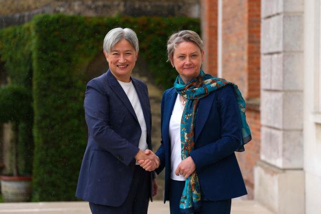 Britain's Foreign Secretary Yvette Cooper (R) welcomes Australia's Foreign Minister Penny Wong (L) at Chevening House Sevenoaks, southern England on June 11, 2026. (Photo by Carl Court / POOL / AFP)