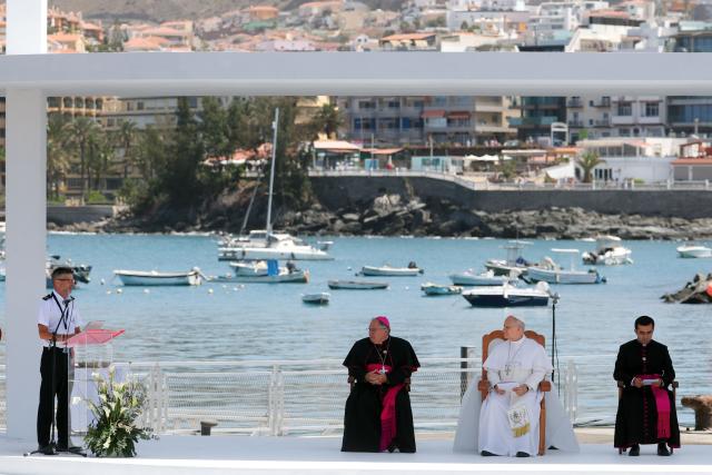 Pope Leo XIV (2R) listens to the speech of a senior official from Spain's Maritime Rescue service during a meeting with organizations working with migrants in the port of Arguineguin on the Canary Island of Gran Canaria, a place accustomed to the arrival of migrants, on June 11, 2026. Pope Leo XIV is visiting Spain June 6-12 with stops in Madrid, Barcelona, and the Canary Islands, where he will meet with migrants and organisations dedicated to helping them. (Photo by Pierre-Philippe MARCOU / AFP)