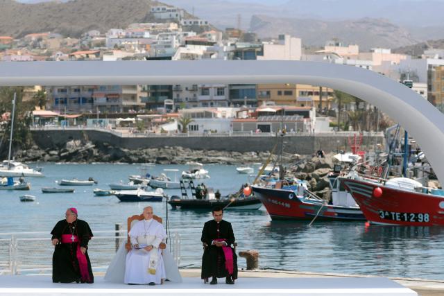 Pope Leo XIV (C) attends a meeting with organizations working with migrants in the port of Arguineguin on the Canary Island of Gran Canaria, a place accustomed to the arrival of migrants, on June 11, 2026. Pope Leo XIV is visiting Spain June 6-12 with stops in Madrid, Barcelona, and the Canary Islands, where he will meet with migrants and organisations dedicated to helping them. (Photo by Pierre-Philippe MARCOU / AFP)