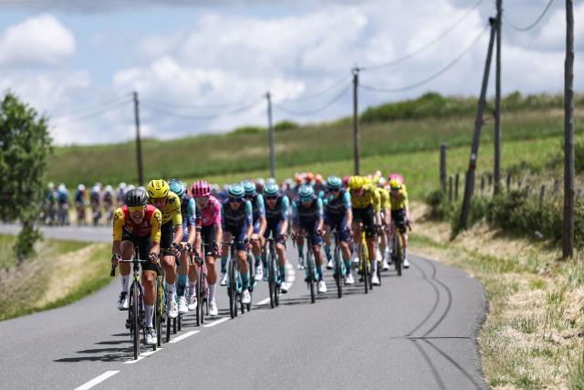 The pack of riders cycles during the 5th stage of the Tour Auvergne-Rhone-Alpes cycling race (formerly known as the Criterium du Dauphine), 195,8km between Saint-Chamond and Villars-les-Dombes, central France, on June 11, 2026. (Photo by Anne-Christine POUJOULAT / AFP)