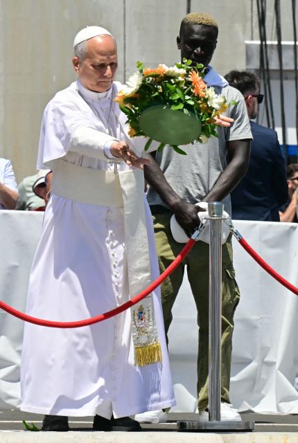 Pope Leo XIV throws a wreath to the sea to remember all the migrants who perished during their journey, at the Port of Arguineguin on the Canary Island of Gran Canaria, a place accustomed to the arrival of migrants, on June 11, 2026. Pope Leo XIV is visiting Spain June 6-12 with stops in Madrid, Barcelona, and the Canary Islands, where he will meet with migrants and organisations dedicated to helping them. (Photo by Stefano RELLANDINI / AFP)