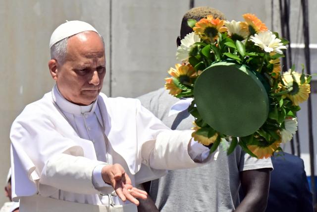 Pope Leo XIV throws a wreath to the sea to remember all the migrants who perished during their journey, at the Port of Arguineguin on the Canary Island of Gran Canaria, a place accustomed to the arrival of migrants, on June 11, 2026. Pope Leo XIV is visiting Spain June 6-12 with stops in Madrid, Barcelona, and the Canary Islands, where he will meet with migrants and organisations dedicated to helping them. (Photo by Stefano RELLANDINI / AFP)