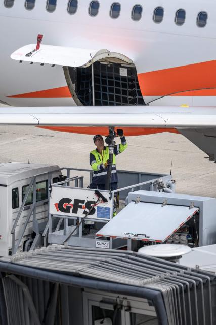 An employee of Geneva Fuelling Services (GFS) refuels an aircraft operated by British low-cost airline EasyJet at Geneva Airport on June 11, 2026. The war in the Middle East and the closure of the Strait of Hormuz have caused a surge in aviation fuel prices and raised concerns about potential shortages this summer. (Photo by Fabrice COFFRINI / AFP)
