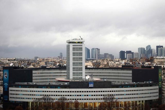 (FILES) This photograph taken on December 19, 2014 shows the Maison de la Radio, which houses Radio France's stations, in Paris, with the La Defense business district visible in the background. Audiovisual regulator the Audiovisual and Digital Communication Regulatory Authority (Arcom) announced on June 11, 2026 that it has issued a formal notice to public broadcaster Radio France over the "under-representation" of far-right Rassemblement National (RN) on its airwaves between January and late March. (Photo by Joël SAGET / AFP)