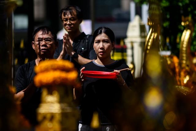 Visitors pray at the Erawan Shrine in Bangkok on June 11, 2026. (Photo by ANTHONY WALLACE / AFP)