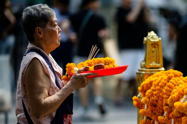 A visitor prays at the Erawan Shrine in Bangkok on June 11, 2026. (Photo by ANTHONY WALLACE / AFP)