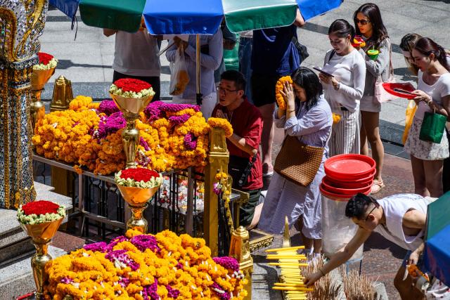 Visitors pray at the Erawan Shrine in Bangkok on June 11, 2026. (Photo by ANTHONY WALLACE / AFP)