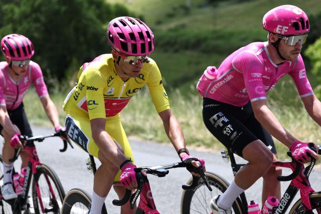 EF Education - EasyPost's French rider Alex Baudin wearing the overall leader's yellow jersey and EF Education - EasyPost's British rider Max Walker cycle during the 5th stage of the Tour Auvergne-Rhone-Alpes cycling race (formerly known as the Criterium du Dauphine), 195,8km between Saint-Chamond and Villars-les-Dombes, central France, on June 11, 2026. (Photo by Anne-Christine POUJOULAT / AFP)