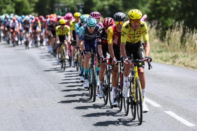 The pack of riders cycles during the 5th stage of the Tour Auvergne-Rhone-Alpes cycling race (formerly known as the Criterium du Dauphine), 195,8km between Saint-Chamond and Villars-les-Dombes, central France, on June 11, 2026. (Photo by Anne-Christine POUJOULAT / AFP)