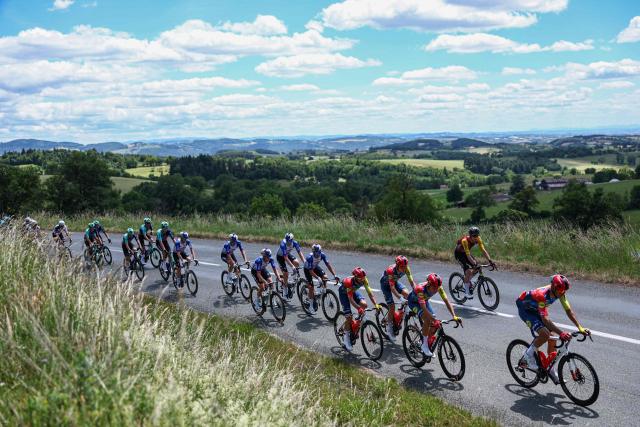 The pack of riders cycles during the 5th stage of the Tour Auvergne-Rhone-Alpes cycling race (formerly known as the Criterium du Dauphine), 195,8km between Saint-Chamond and Villars-les-Dombes, central France, on June 11, 2026. (Photo by Anne-Christine POUJOULAT / AFP)