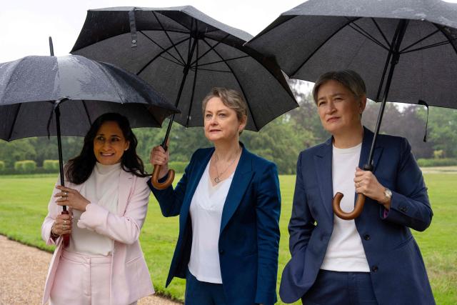 Britain's Foreign Secretary Yvette Cooper (C) walks with Australia's Foreign Minister Penny Wong (R) and Canada's Foreign Minister Anita Anand (L) in the garden at Chevening House in Sevenoaks, southern England on June 11, 2026. (Photo by Carl Court / POOL / AFP)