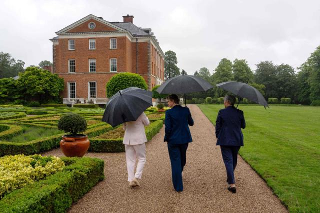 Britain's Foreign Secretary Yvette Cooper (C) walks with Australia's Foreign Minister Penny Wong (R) and Canada's Foreign Minister Anita Anand (L) in the garden at Chevening House in Sevenoaks, southern England on June 11, 2026. (Photo by Carl Court / POOL / AFP)