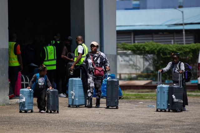 A Nigerian passenger and her daughters push their luggage on arrival from South Africa at the Murtala Muhammed International Airport in Lagos, on June 11, 2026. The first group of Nigerians repatriated from South Africa following escalating anti-immigrant attacks landed in Lagos on June 11, 2026. (Photo by TOYIN ADEDOKUN / AFP)