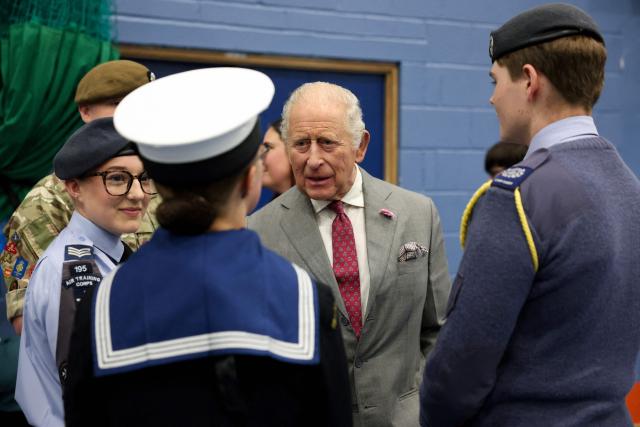 Britain's King Charles III (C) reacts as he talks with with Army, Air and Sea Cadets during a visit to Horizon Youth Zone, a new centre aimed at providing a safe and inspiring place for young people and offering multiple activities including sports, cooking, creative and performing arts, in the city of Grimsby, north-east England, on June 11, 2026. (Photo by Temilade Adelaja / POOL / AFP)