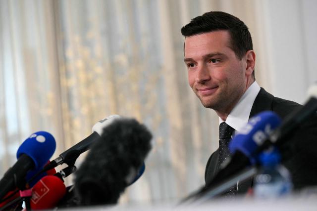 French far-right Rassemblement National RN party's President and Member of the European Parliament (MEP) Jordan Bardella reacts flanked by President of Belgian and Flemish far-right party Vlaams Belang (VB) as they hold a press briefing at the headquarters of Belgian and Flemish far-right party Vlaams Belang as part of Bardella's meeting with Flemish far-right representatives in Brussels on June 11, 2026, a new opportunity to strengthen his European alliances just a few months before the upcoming French presidential election. (Photo by NICOLAS TUCAT / AFP)