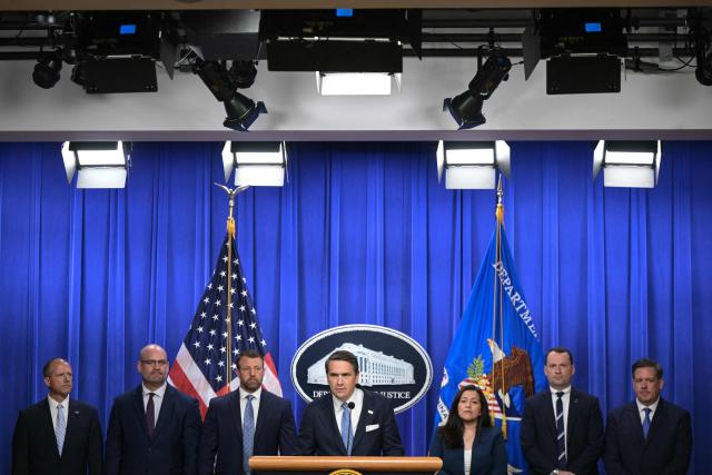 US Acting Attorney General Todd Blanche (C), alongside Secretary of Homeland Security Markwayne Mullin (3L), speaks during a press conference about safeguarding unaccompanied immigrant children at the Department of Justice headquarters in Washington, DC, on June 11, 2026. (Photo by Oliver Contreras / AFP)