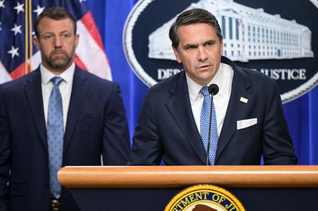 US Acting Attorney General Todd Blanche (R), alongside Secretary of Homeland Security Markwayne Mullin (L), speaks during a press conference about safeguarding unaccompanied immigrant children at the Department of Justice headquarters in Washington, DC, on June 11, 2026. (Photo by Oliver Contreras / AFP)