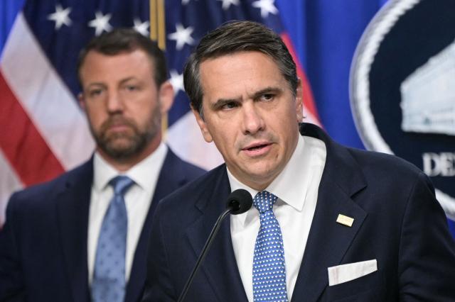 US Acting Attorney General Todd Blanche (R), alongside Secretary of Homeland Security Markwayne Mullin (L), speaks during a press conference about safeguarding unaccompanied immigrant children at the Department of Justice headquarters in Washington, DC, on June 11, 2026. (Photo by Oliver Contreras / AFP)