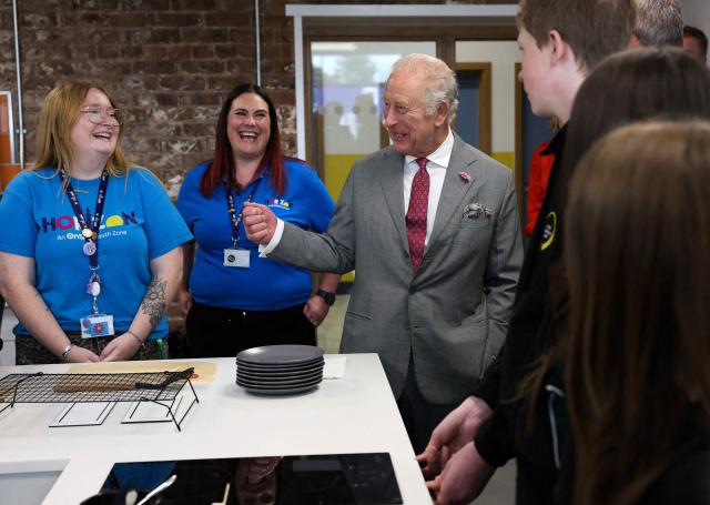 Britain's King Charles III (R) reacts during a visit to Horizon Youth Zone, a new centre aimed at providing a safe and inspiring place for young people and offering multiple activities including sports, cooking, creative and performing arts, in the city of Grimsby, north-east England, on June 11, 2026. (Photo by Temilade Adelaja / POOL / AFP)