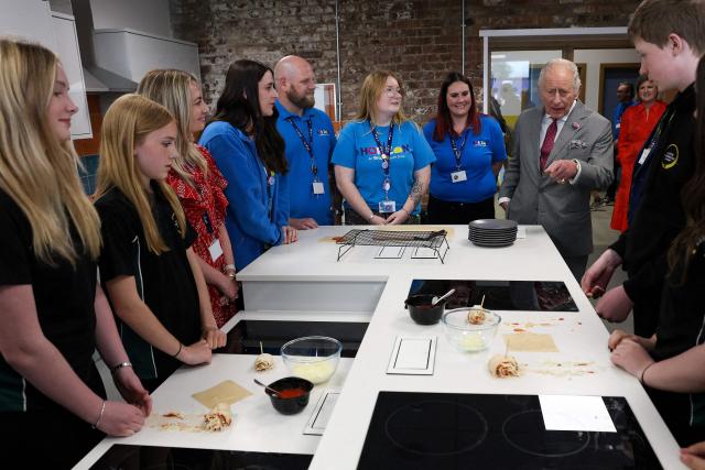 Britain's King Charles III (R) reacts during a visit to Horizon Youth Zone, a new centre aimed at providing a safe and inspiring place for young people and offering multiple activities including sports, cooking, creative and performing arts, in the city of Grimsby, north-east England, on June 11, 2026. (Photo by Temilade Adelaja / POOL / AFP)