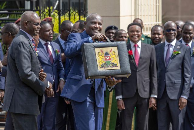 Kenya's National Treasury and Economic Planning Cabinet Secretary John Mbadi holds the 'budget briefcase' after he arrived at parliament buildings to read the 2026-2027 financial year national budget in Nairobi on June 11, 2026. (Photo by Tony KARUMBA / AFP)
