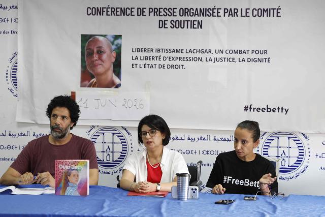 The sister of Ibtissame Lachgar, Siham Lachgar (R) attends a press conference with her sister's lawyer Ghizlane Mamouni (C) and Hakim Sikouk (L) president of the Moroccan Association for Human Rights (AMDH) to speak on her critical health condition at the AMDH headquarters in Rabat on June 11, 2026. A Moroccan court on September 3, sentenced activist Ibtissame Lachgar to 30 months behind bars for "offending Islam" by wearing a T-shirt with inscriptions deemed "blasphemous". (Photo by Abdel Majid BZIOUAT / AFP)