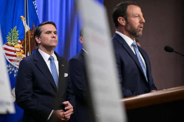 (L/R) US Acting Attorney General Todd Blanche looks on as Secretary of Homeland Security Markwayne Mullin speaks during a press conference about safeguarding unaccompanied immigrant children at the Department of Justice headquarters in Washington, DC, on June 11, 2026. (Photo by Oliver Contreras / AFP)